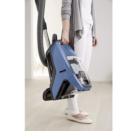 Carrying the Miele Blizzard CX1 PowerLine Vacuum Cleaner.